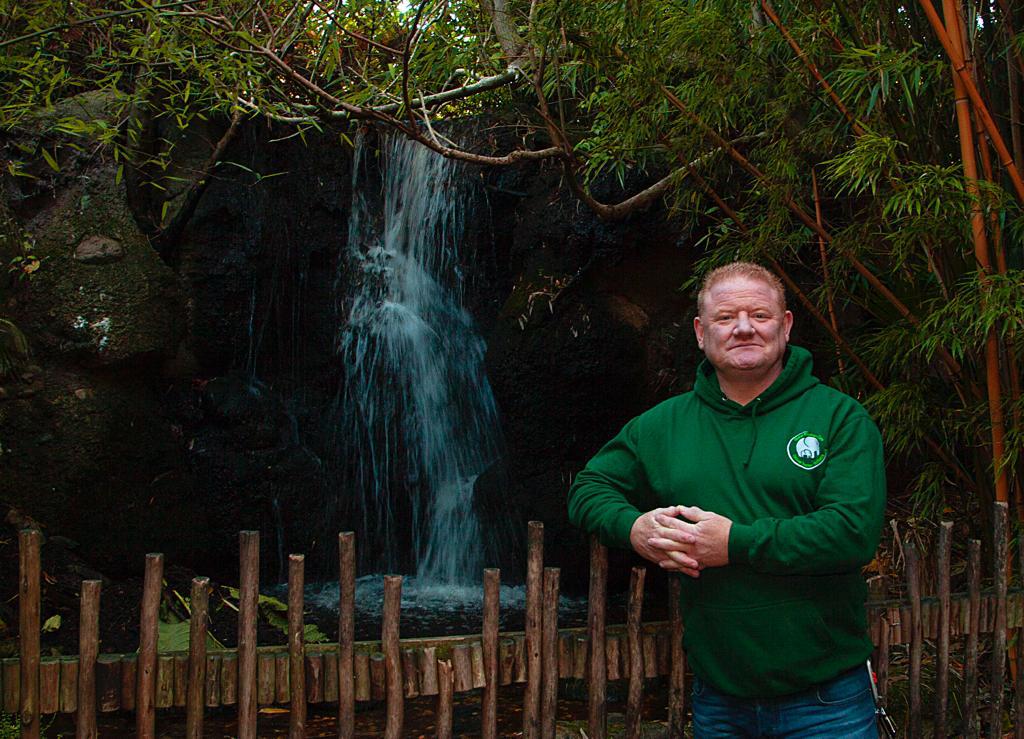 Gerry Creighton standing in front of a small waterfall